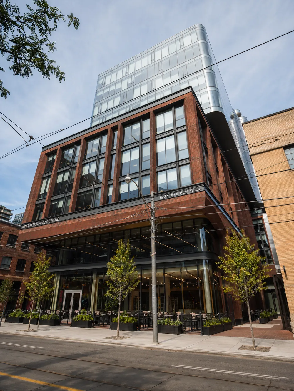 620 King Street West tower exterior from the street — King Portland Centre, brick base with curved glass tower