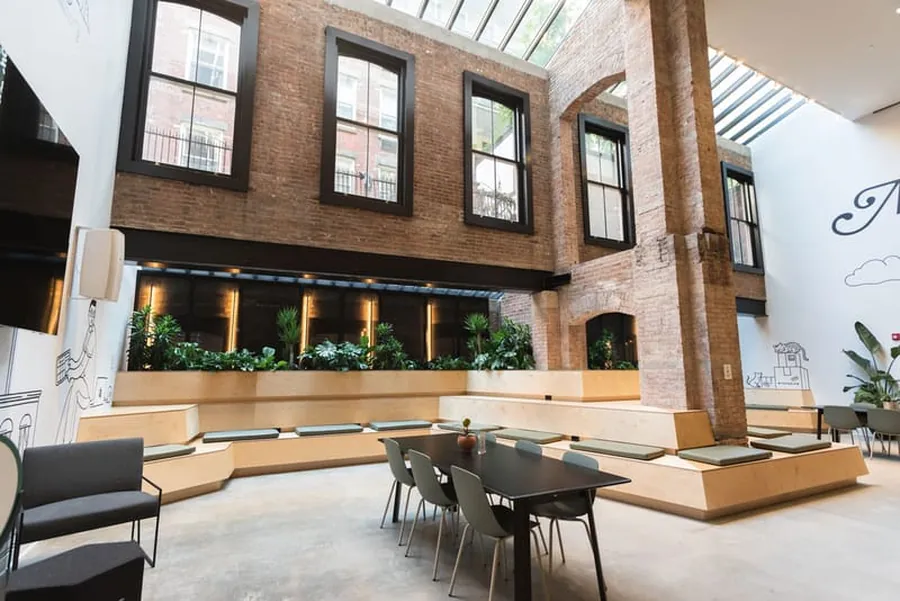 Shopify Soho skylit brick atrium with tiered seating